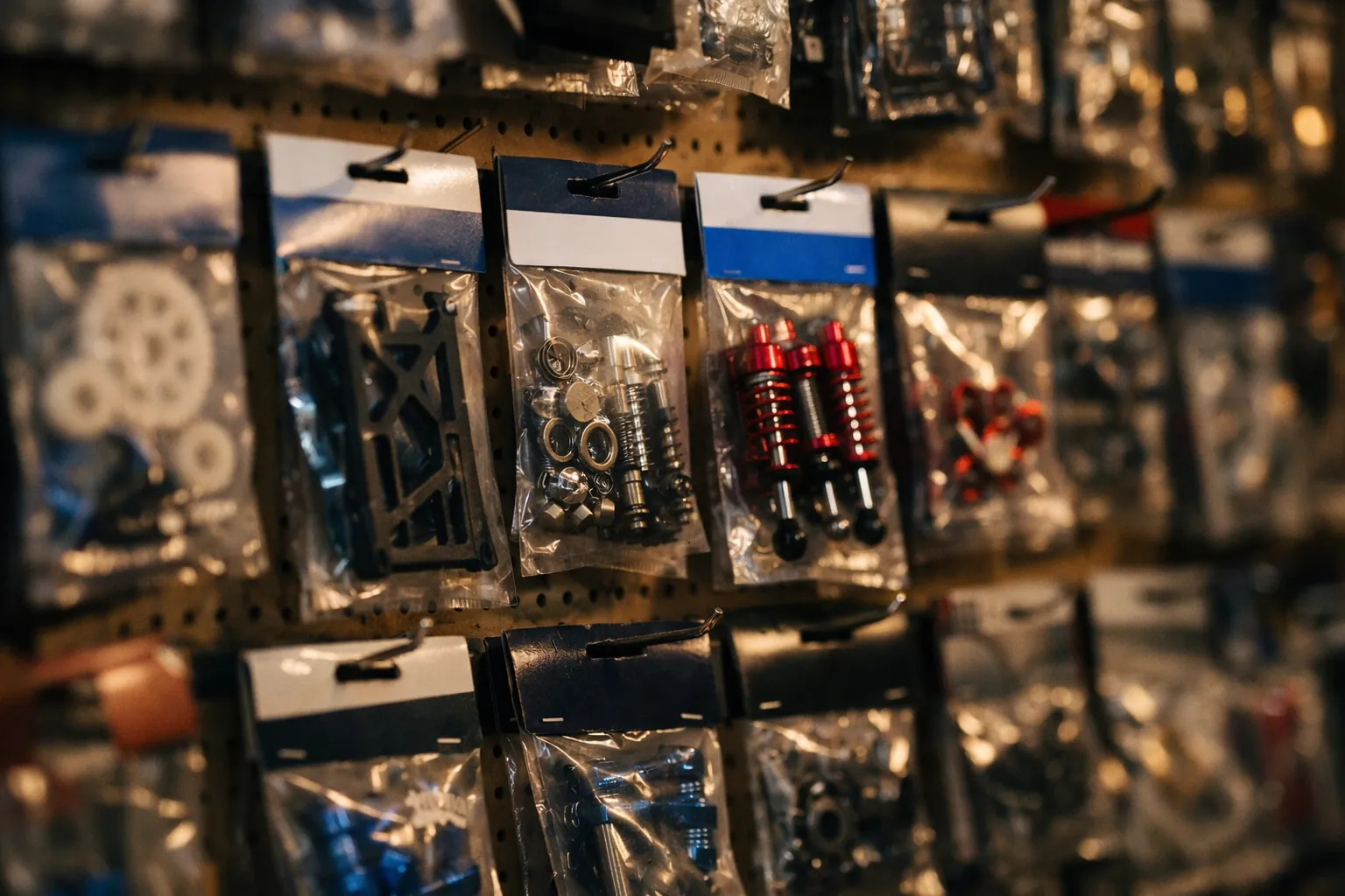 A hobby shop wall of RC replacement parts in blister packs